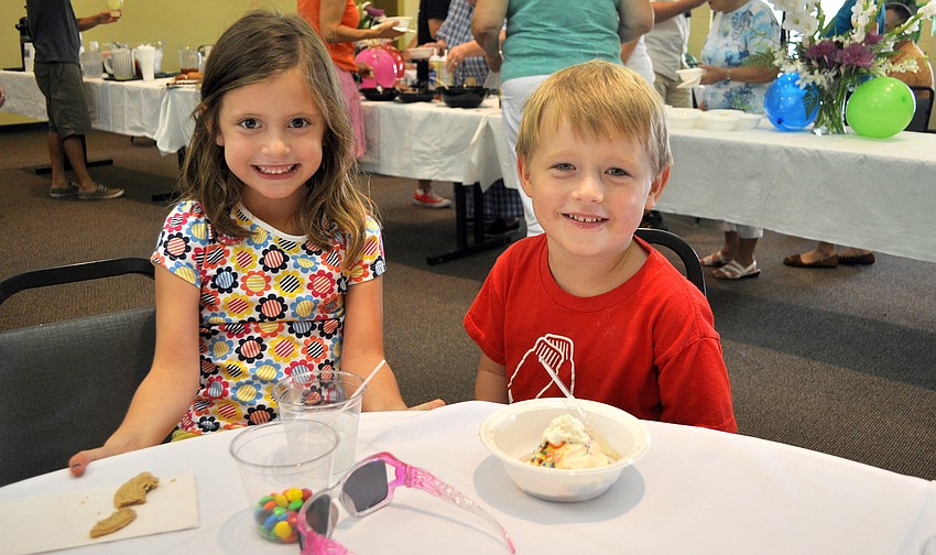Sophie Buchmeier, 5, and Sawyer Soboleski, 5, sit together at a table in the Parish Hall.