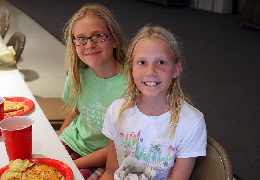 Twins Hailey and Bailey, 11, Ballard pose together Friday, Aug. 26 in the Parish Hall.