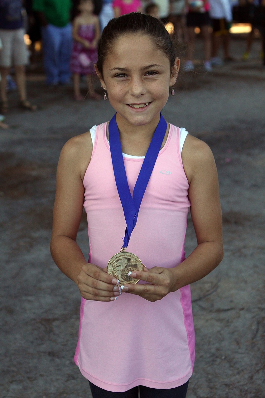 Sharalyn Hibbins, 9, won first place in her age group for girls on Saturday, April 2 in the 25th Annual Run for the Turtles on Siesta Key Beach.