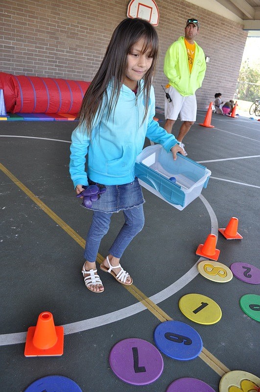 Jamie Flores, 8, tried to toss animals onto numbered pads.