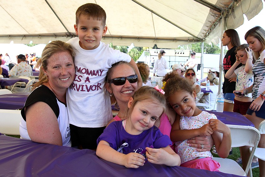 Survivor Amanda Worth poses with her son, Anthony, and her friends Samantha and Chloe Cook and Sydney Fieber during Relay For Life on Saturday, April 9 at Sarasota High School.