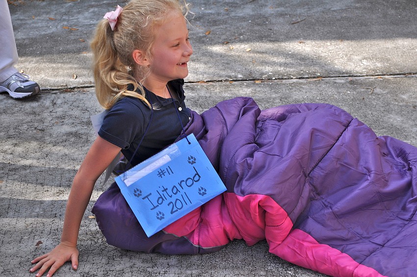 Esme Cullum slips into a sleeping bag as part of the race.