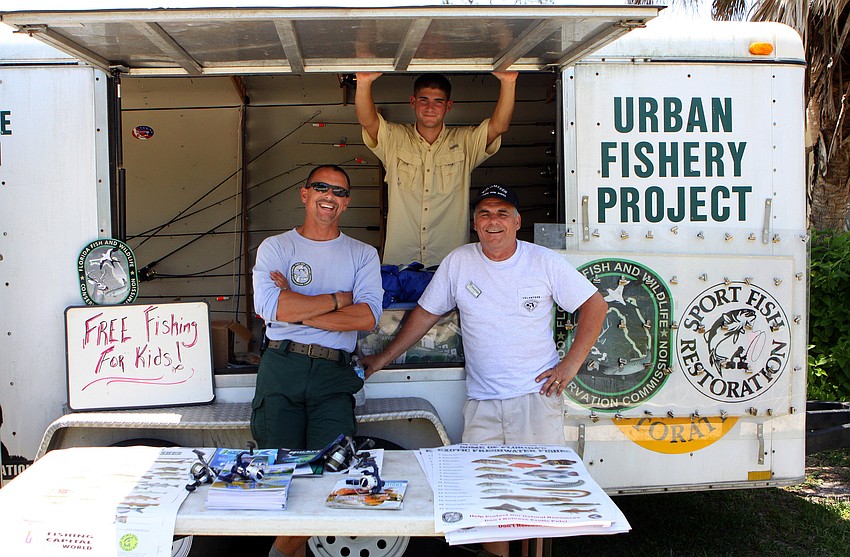 Paul Thomas, Jack Pietrantone and Steve Michalski pose in front of the Urban Fishery Project trailer where they worked during the Earth Day Celebration on Sunday, April 17 out at Oscar Scherer State Park in Osprey.