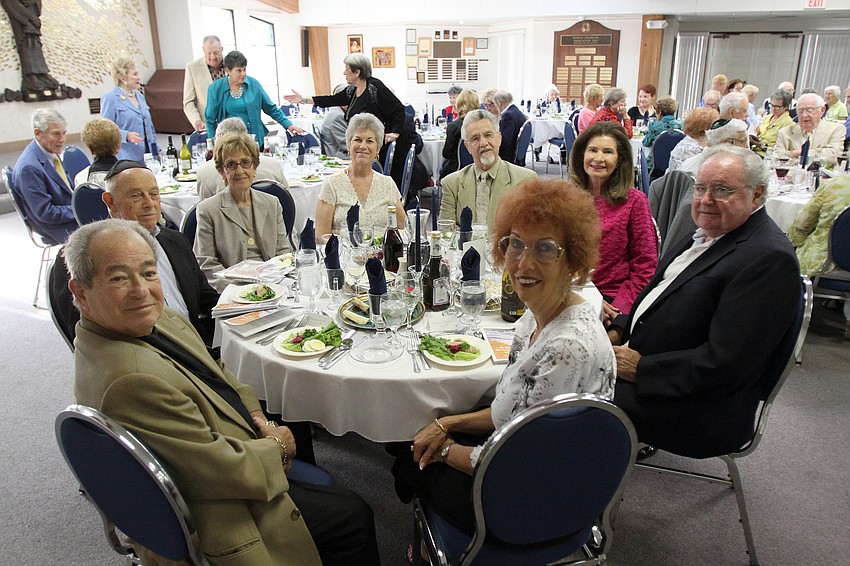 George Fuchs, Larry and Shelia Maslow, Anne and Wally Bishop, Linda Weiss, Joe Hibbard and Barbara Fuchs wait for the Seder dinner to be served on Monday, April 18 at Temple Emanu-El.