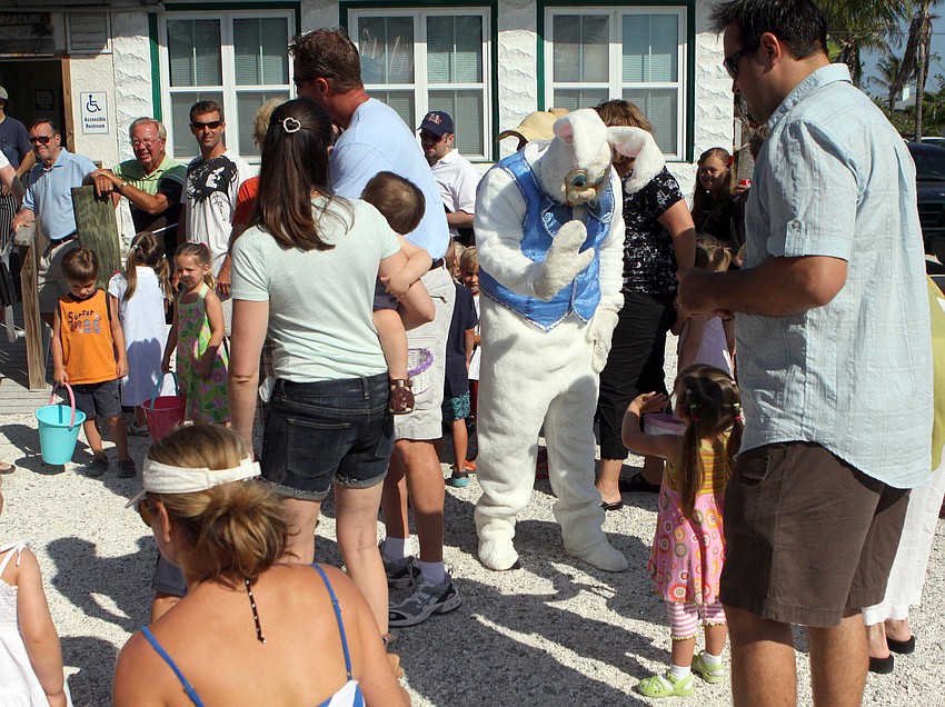 Kids and their parents watch as the Easter Bunny makes his rounds to say hello on Saturday, April 23 at Mar Vista.