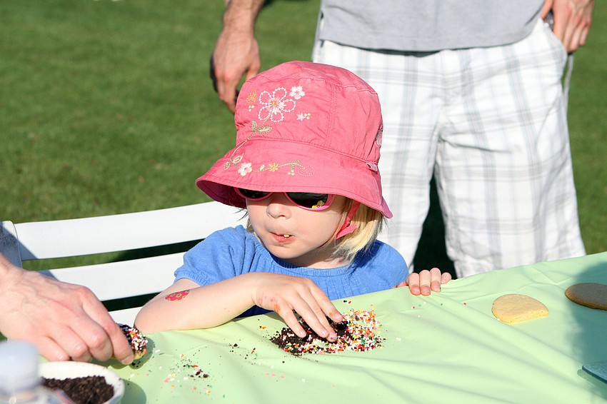 Madeline Noel, 4, enjoys eating the chocolate and sprinkles that fell off the cookie she decorated Sunday, April 24 at Longboat Key Club's Annual Easter egg hunt event.