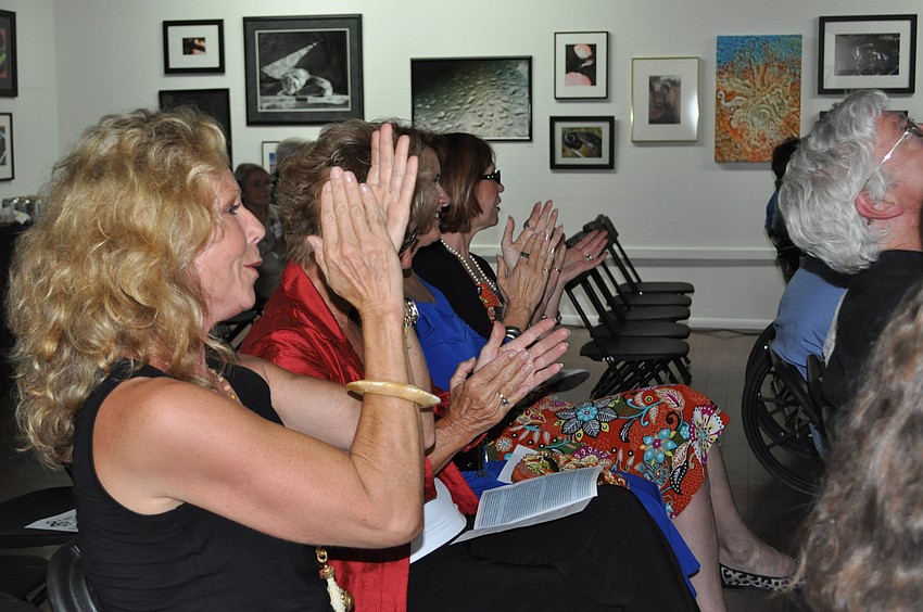 The audience applauds the musicians and dancers.