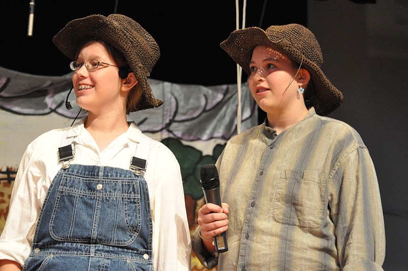 Farmhands Nadine Curtis and Jenny Kleer encourage Dorothy.