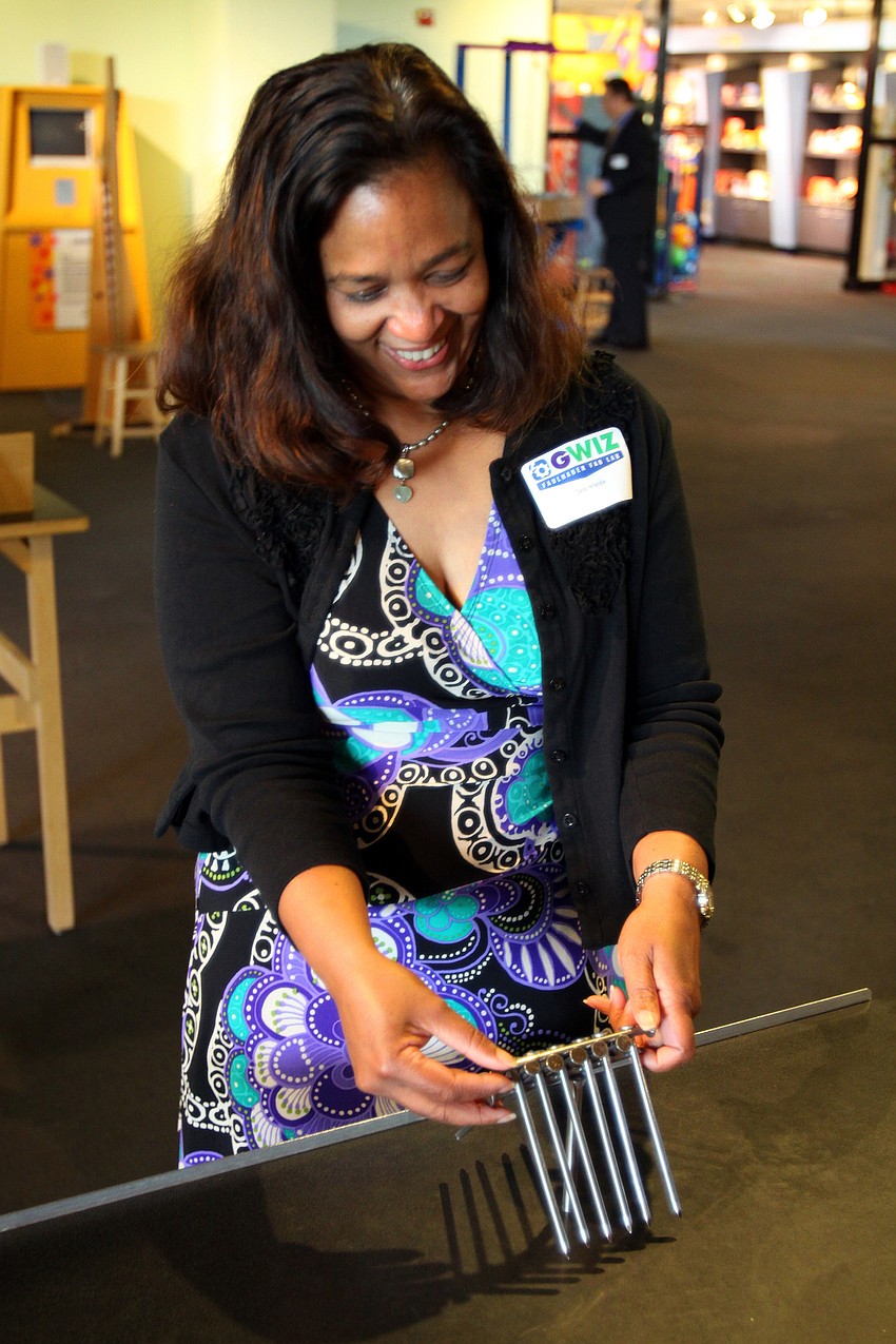 Celia Wardle tries out one of the exhibits in the main part of the museum at the opening of the G. WIZ Faulhaber Fab Lab Thursday, May 5 at G. WIZ.