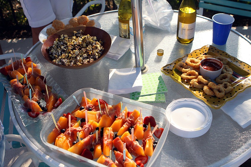 A table of chocolate covered popcorn, fruit and calamari were some of the snacks at Harbour Circle's End of Season BBQ Sunday, May 22 at the pool.
