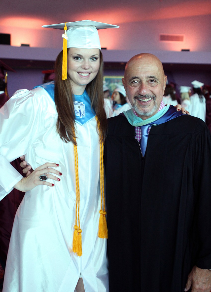 Kristin Fields poses with Mr. Charles Salamone, history and government teacher, prior to graduating Friday, May 27 at the Van Wezel Performing Arts Hall.