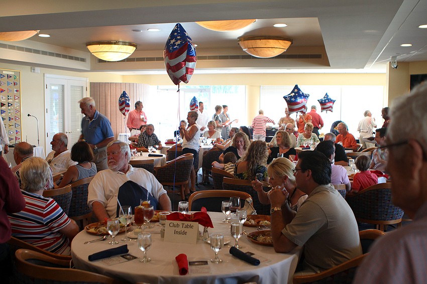 People enjoy their food Saturday, May 28 at Bird Key Yacht Club's Memorial Day party.