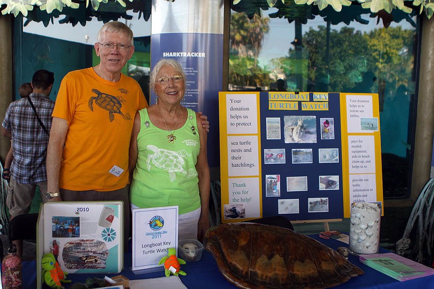 Bill Hamilton and Marie Cecelia Riepenhoff of Longboat Key Turtle Watch pose together by their table at the World Ocean Day Family Festival Sunday, June 5 at Mote Aquarium.