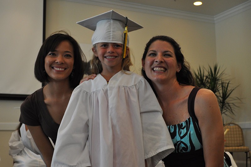 Paige McElyea was all smiles as she received her diploma from her teachers, Jayna Armstrong, left, and Susan Artemik, right.