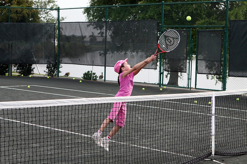 Kerry Lum, 7, reaches for a high volley during Longboat Key Club's Sports Camp Monday, June 6 at Longboat Key Club's Tennis Gardens.
