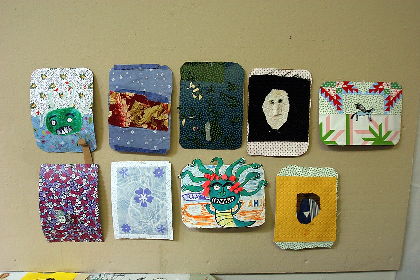 The Medusa shields made by the students participating in the It's All Greek To Me! summer art class at Art Center Sarasota hang on the wall to dry.