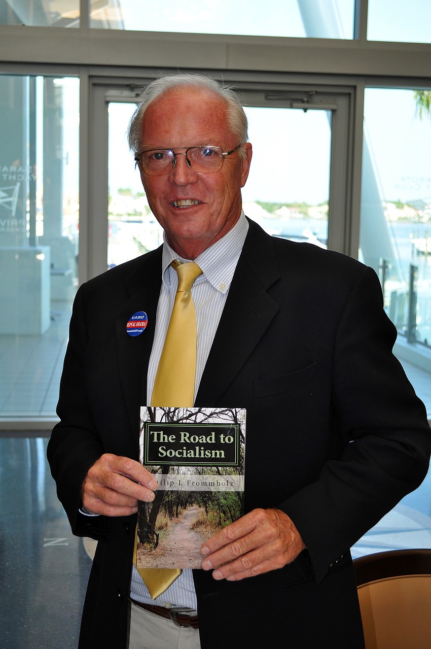Philip L. Frommholz poses with his book 