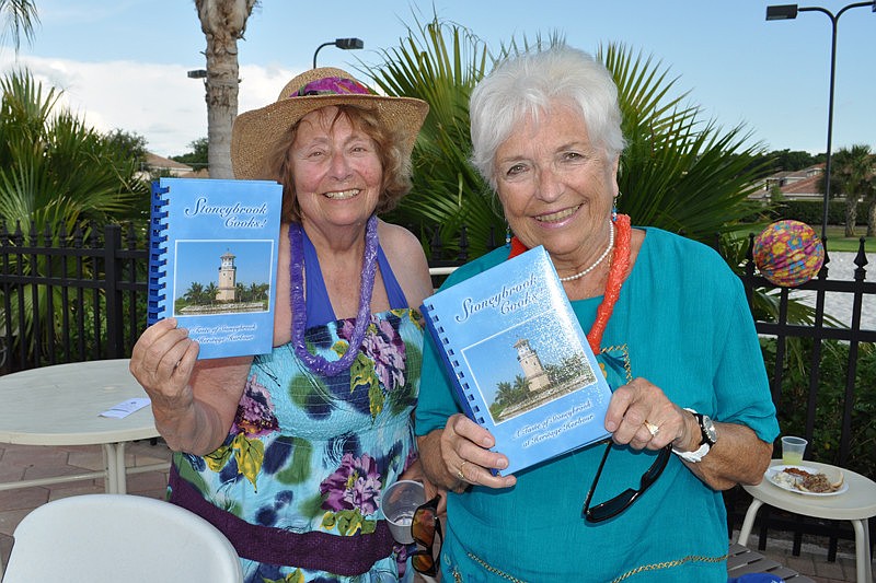 Linda Buxbaum and Carol Eichert sold Stoneybrook cookbooks to raise money for the Helping Hands club.
