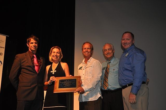 Paul Carter and Kerrie Lehnert, right, and Robert Dinan, far left, all of Kitchens by Kerrie, accept their award from Steve Schewe and Dennis Hassell.