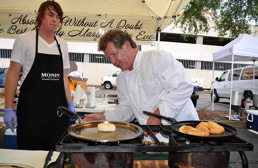 Kyle Klante looks on as Chef James Besterre, of Annalida's, works on frying up the lump crabmeat for a crab cake sandwich.