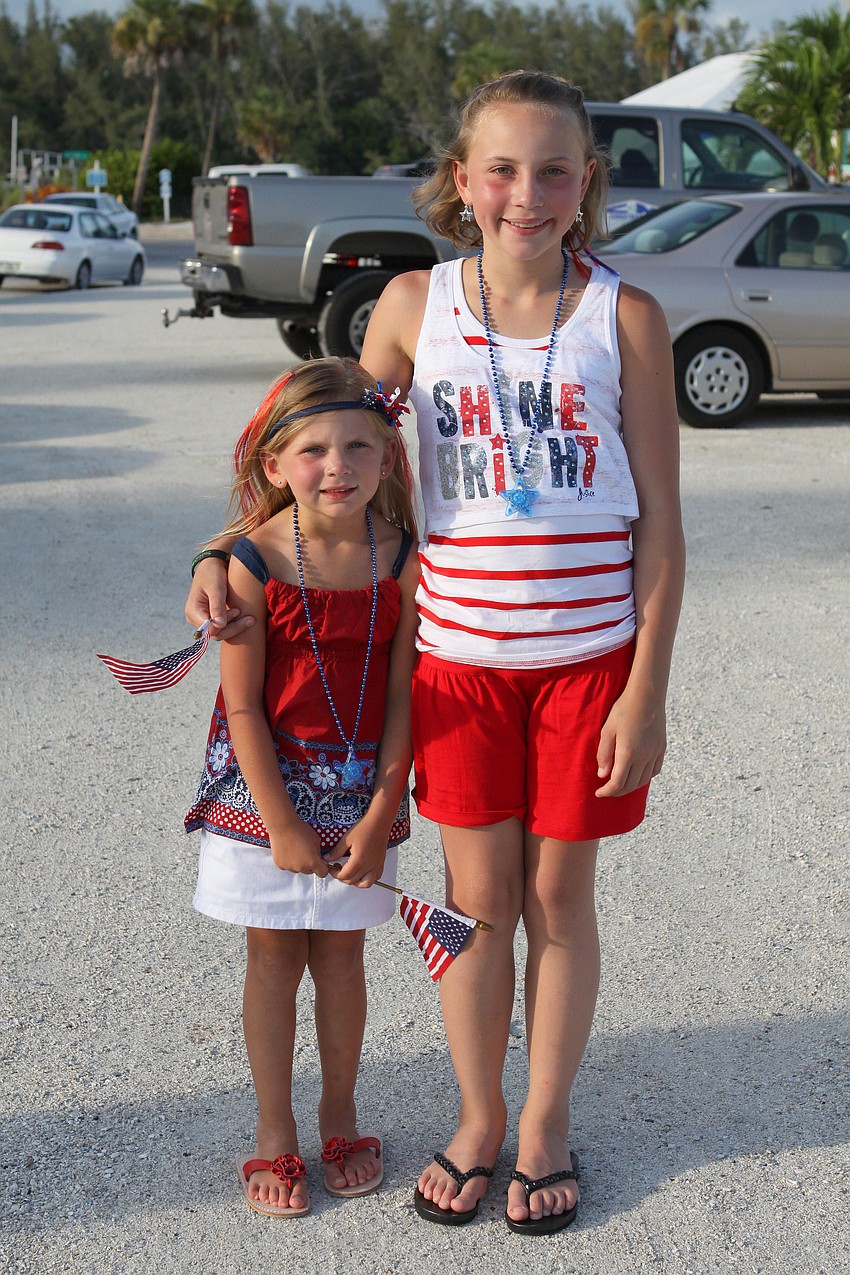 Elle Stubbs, 5, and Isabella Gaudio, 10 1/2, pose before heading to Moore's Stone Crab for dinner and fireworks.