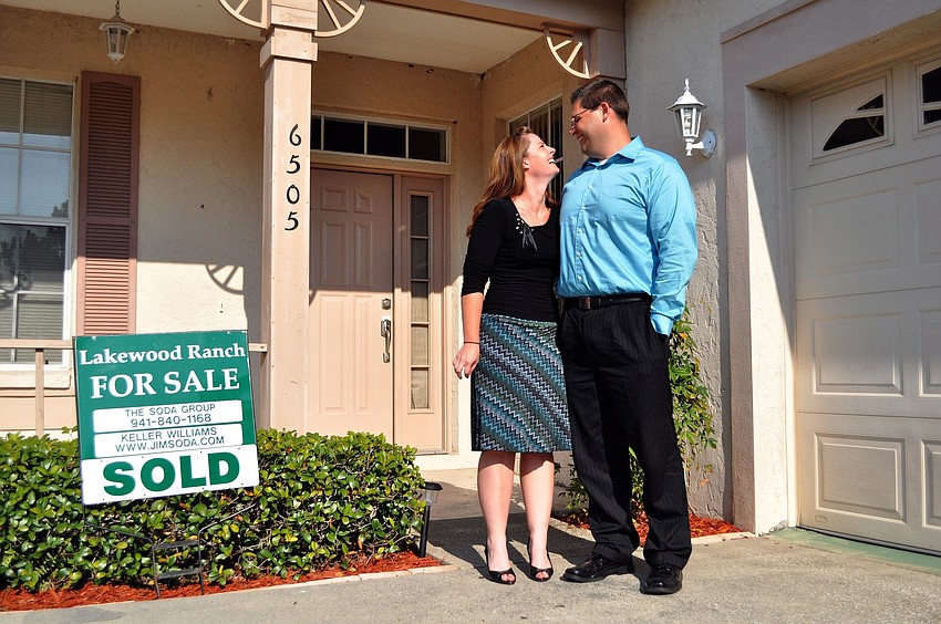 Valerie Stephens smiles up at her fiancÃ©, Jonathan Treadway, as they pose in front of their first home out in Lakewood Ranch. The couple bought their home in April and will getting married on October 15, 2011.