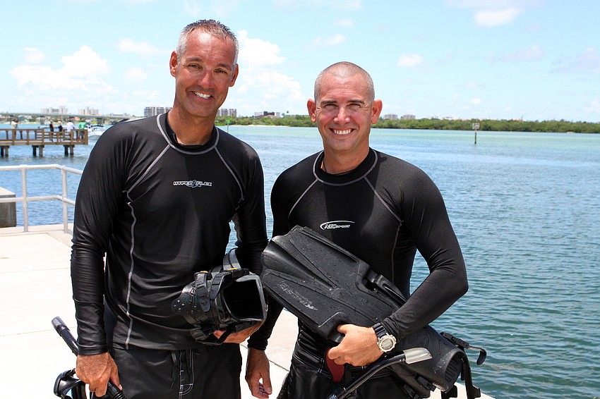 Deputy sheriffs Matt Binkley and Mike Watson pose together after completing the mock marine search and rescue mission Thursday, July 21 at Ken Thompson Park Boat Ramp