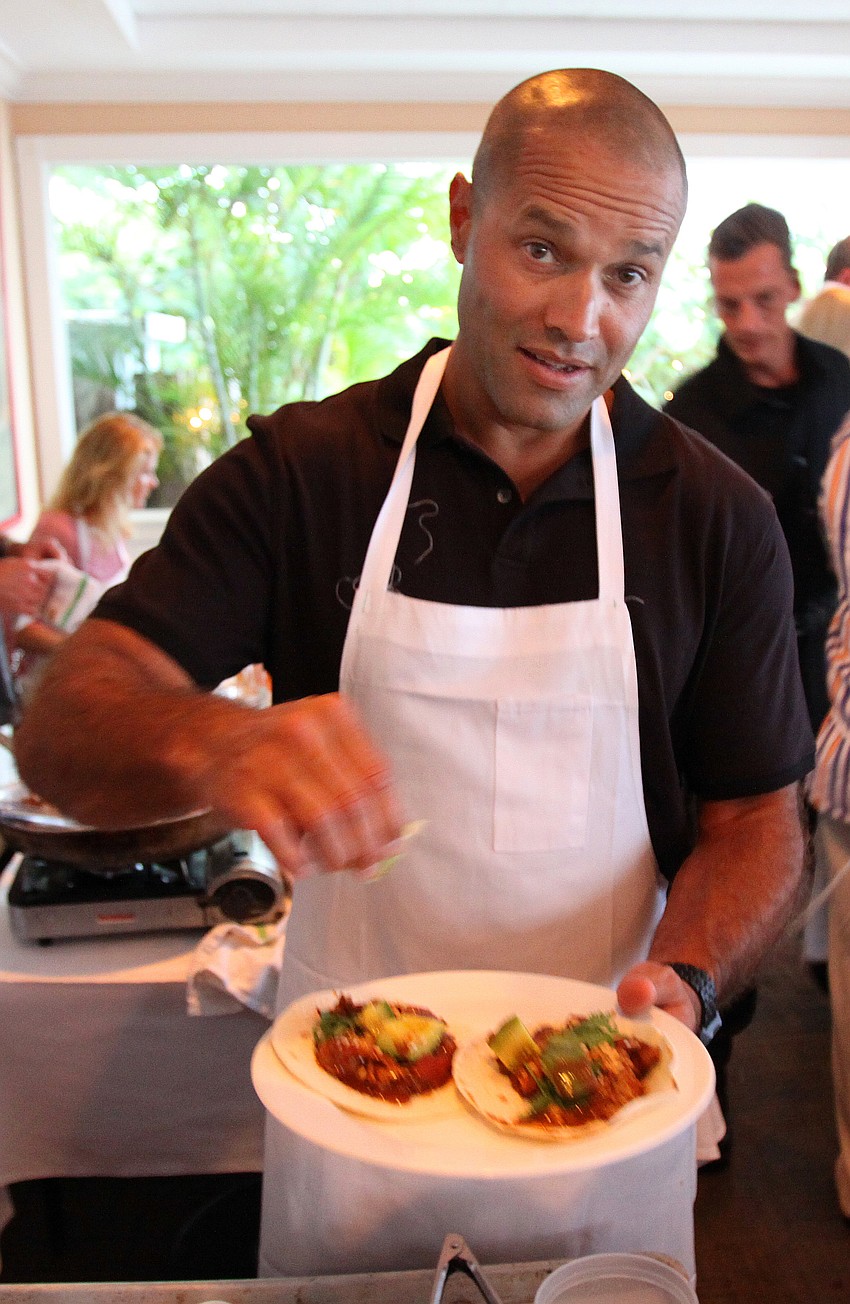 Giovanni DeCastro garnishes the chicken mole dish he made Friday, July 22 during the Interactive Mexico dinner at Pattigeorgeâ€™s. â€œI want a job here,â€ said DeCastro to Tommy Klauber.
