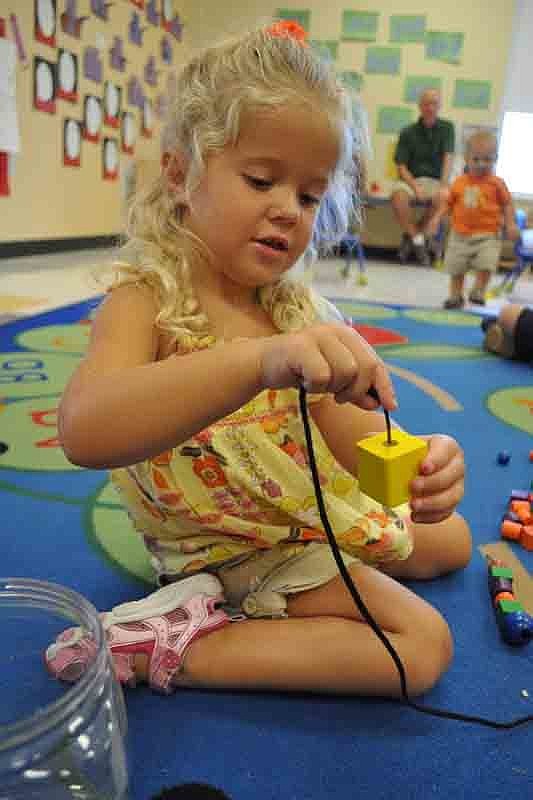 Kenzie Jakubauskas, 3, put her beads in a pattern.