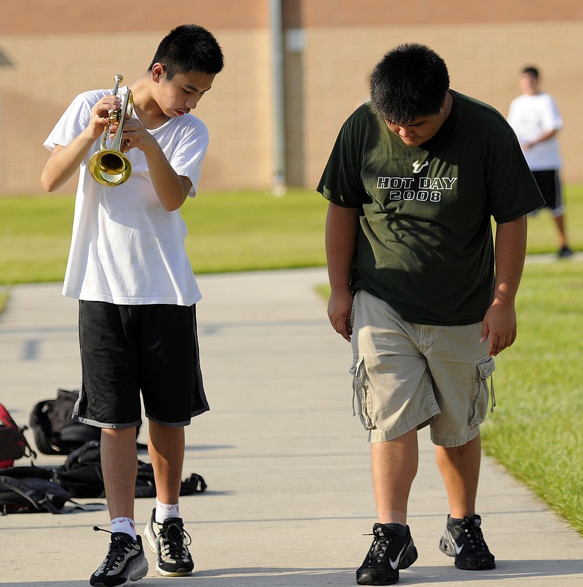 Staff member Donny Huynh, right, works on steps with freshman Johnny Dong.