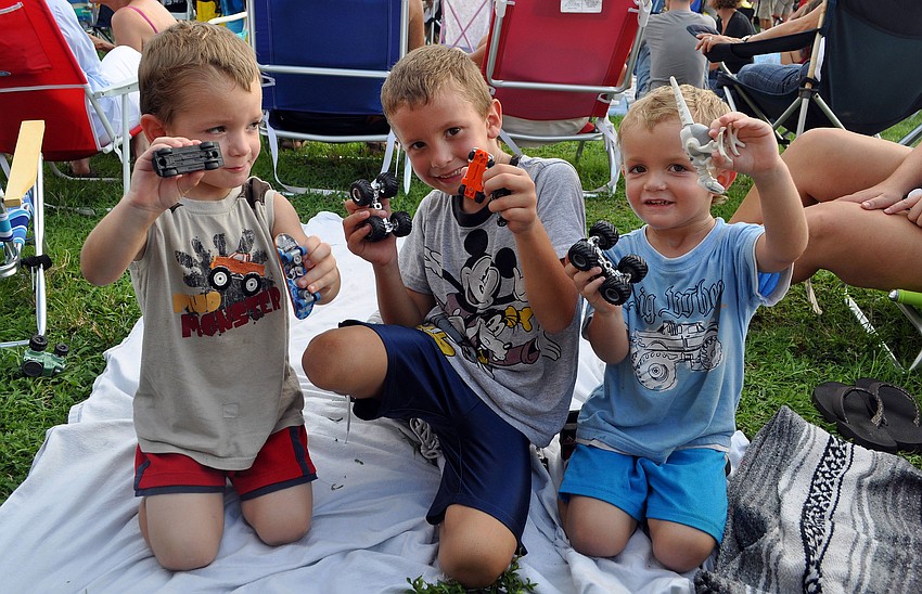 Kaleb, 2, Cody, 6, and Kyle, 2, King show off the toy trucks they brought Friday, August 12 to Friday Fest at the Van Wezel.