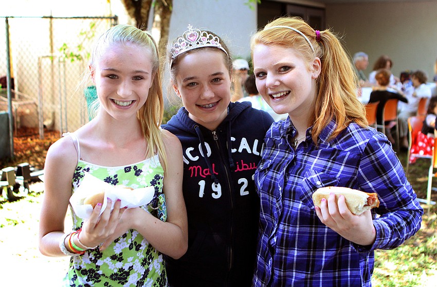 Alicia Stevens, 13, Taylor McCart, 13, and Kendal Sheckler, 13, enjoy some food and pose together on Sunday, March 20 at Temple Emanu-El's Purim Carnival.