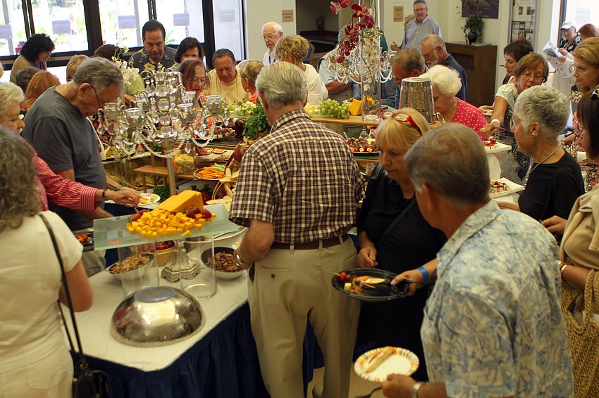 People fill their plates with appetizers on Sunday, March 27 during the opening reception for the second annual Jewish Film Festival.