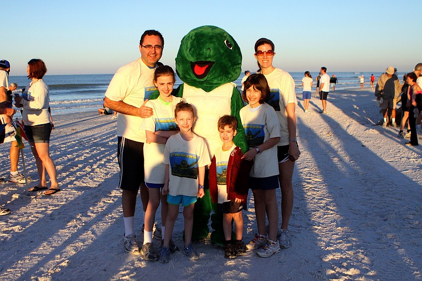 Rami, Isabella, 10, Ava, 7, Quentin, 4, Sophia, 9, and Stephanie Ubaydi pose with Shelly on Saturday, April 2 during the 25th Annual Run for the Turtles on Siesta Key Beach.