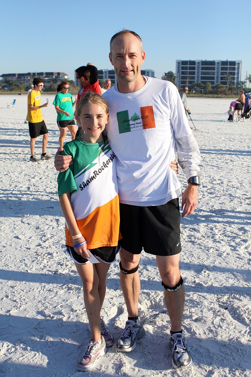 Meredith, 11, and Jason Swift pose together on Saturday, April 2 after finishing the 25th Annual Run for the Turtles on Siesta Key Beach.