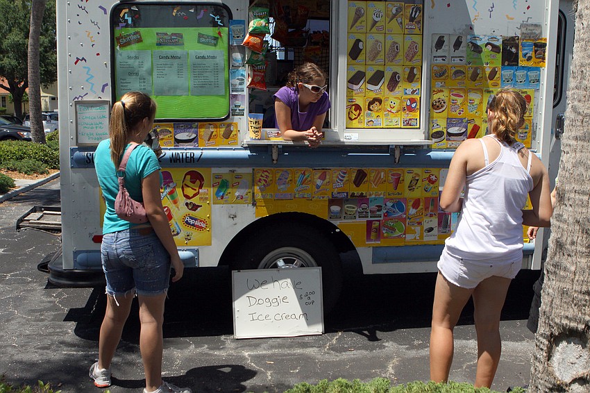 Angelina Eksine stands inside the ice cream truck while Sage Patalano, left, eats some ice cream and Karin Prins decides on what to get on Sunday, April 17 during South Bay's Family Fun Day.