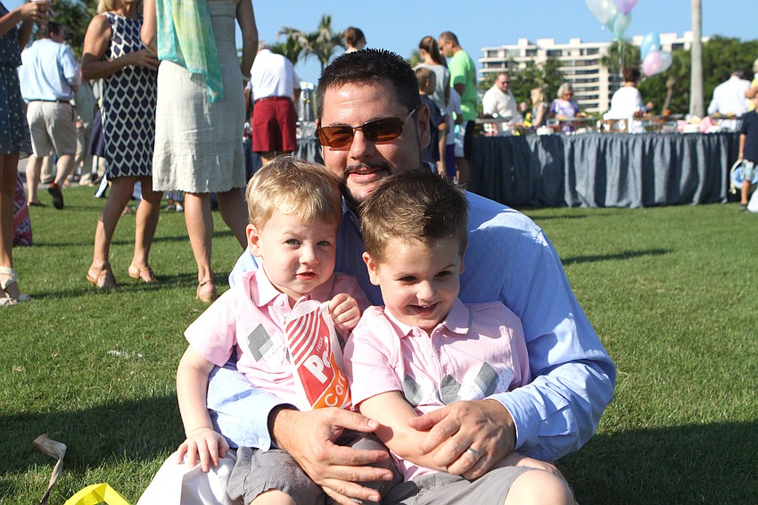 Drew Griffin poses with his sons Cort, 2, and Roman, 4, Sunday, April 24 at Longboat Key Club's Easter egg hunt.