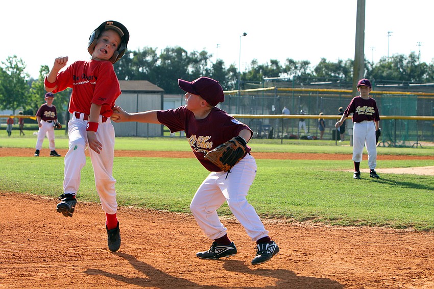 Owney Haney, #5, tags out Josh Fields, #11, during their final game of the Spring season Monday, May 9 at Twin Lakes Park.