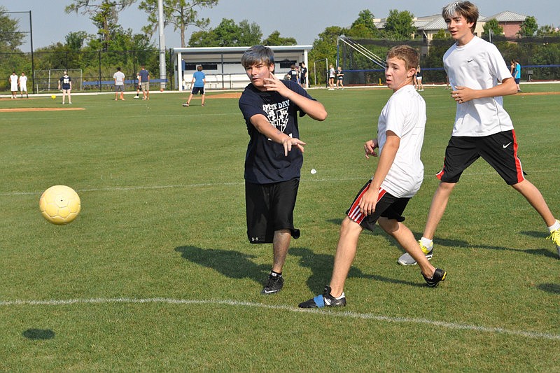 Jonathan Furman, left, takes a shot for a goal during a game of handball.