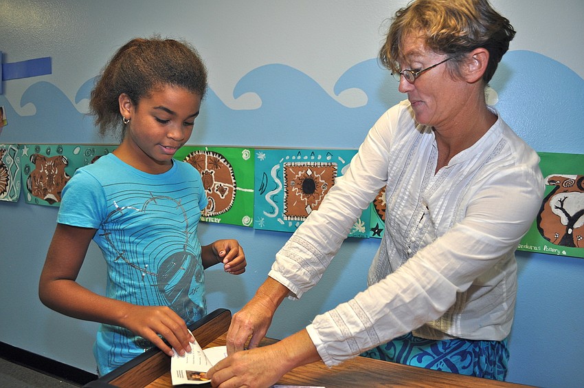 Immigration inspector Theresa Ramsey stamps Natasha Guerrero's passport.