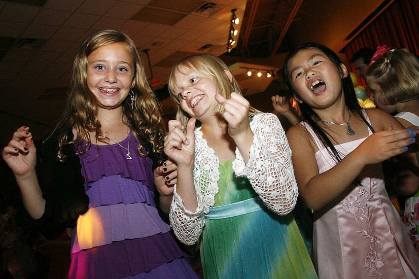 Zoe Gillson, left, and Hailey Mallard, center, were among the first to hit the dance floor.