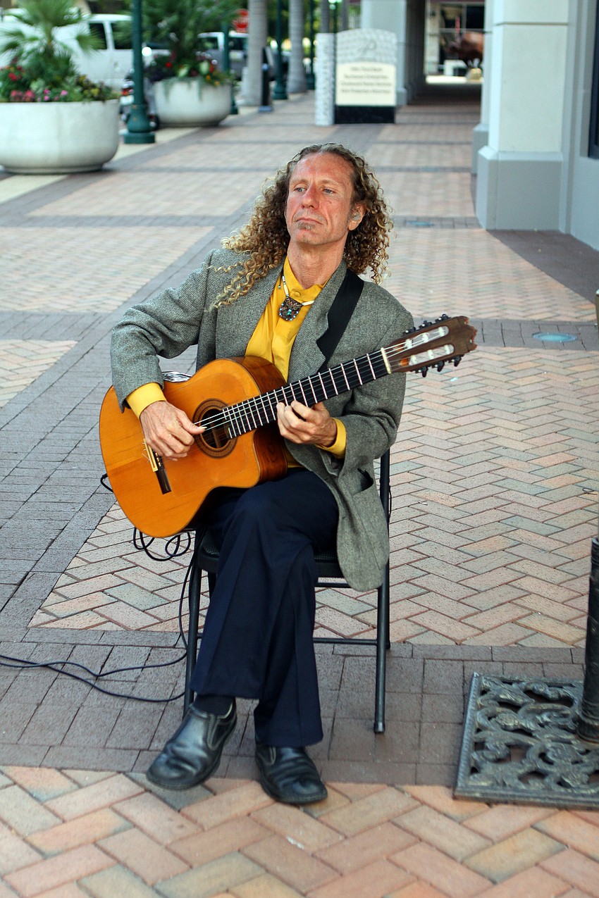 Russell Donnellon plays his guitar ans sold his CDs at the Craft Festival Sunday, May 22 along Main Street and in Five Points Park.