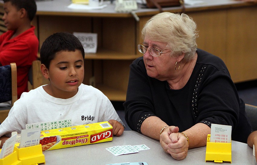 Said Rasid gets some help from Iris Wilson, the lead bridge coach of Gocio's bridge club, during the bridge club's final meeting Monday, May 23 inside Gocico Elementary School's Media Center.