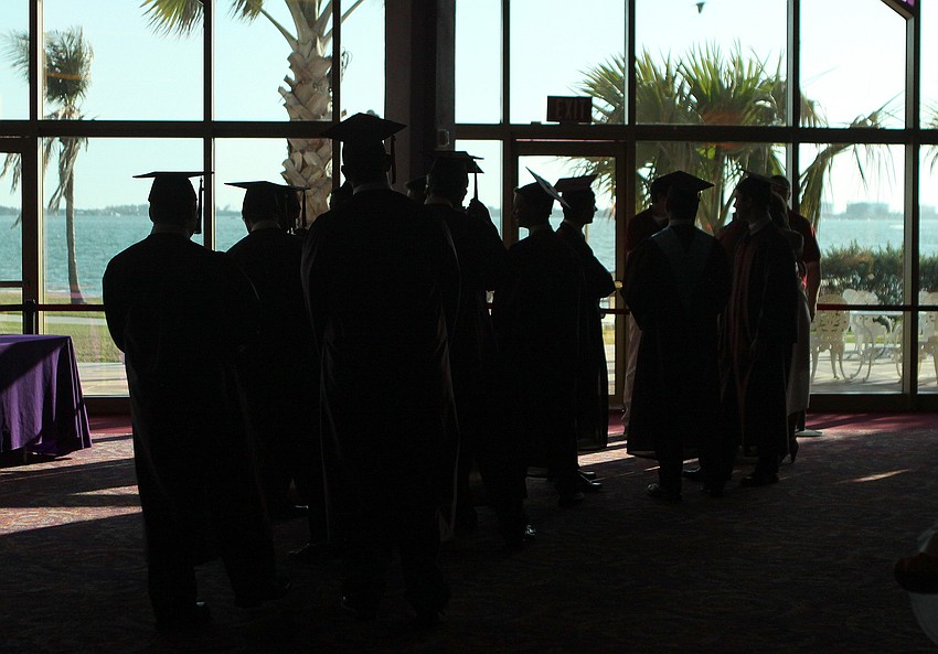 Silhouetted Cardinal Mooney seniors get ready to graduate Friday, May 27 at the Van Wezel Performing Arts Hall.
