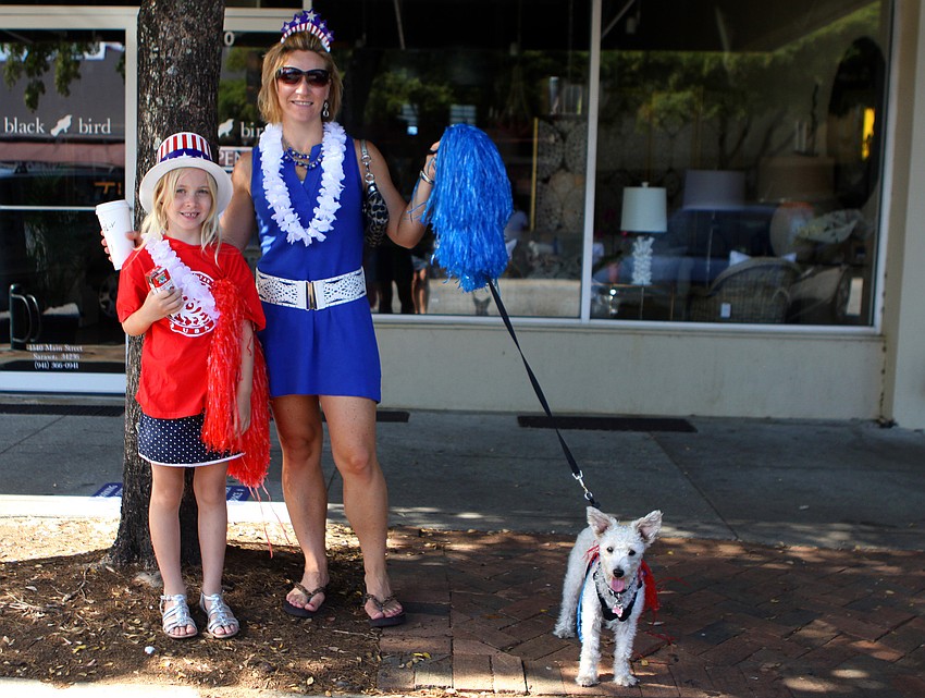 Abigail and Heather Koester with their dog, Lilly, get ready to watch the Memorial Day parade.