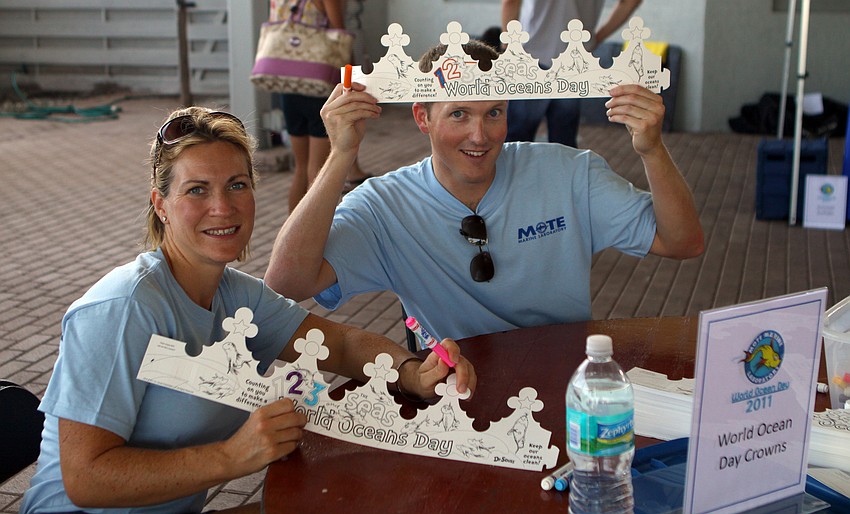 Heather Koester and Justin Rees volunteered to help kids make Dr. Seuss inspired World Ocean Day crowns during the World Ocean Day Family Festival Sunday, June 5 at Mote Aquarium.