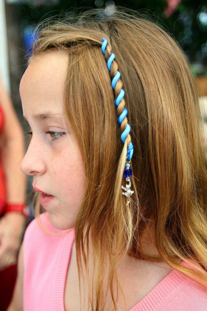 Tierney Merritt, 9, wears her new Hair Fancy that her mother bought her at the 10th Annual St. Armands Craft Festival Saturday June, 11 at St. Armands Circle.