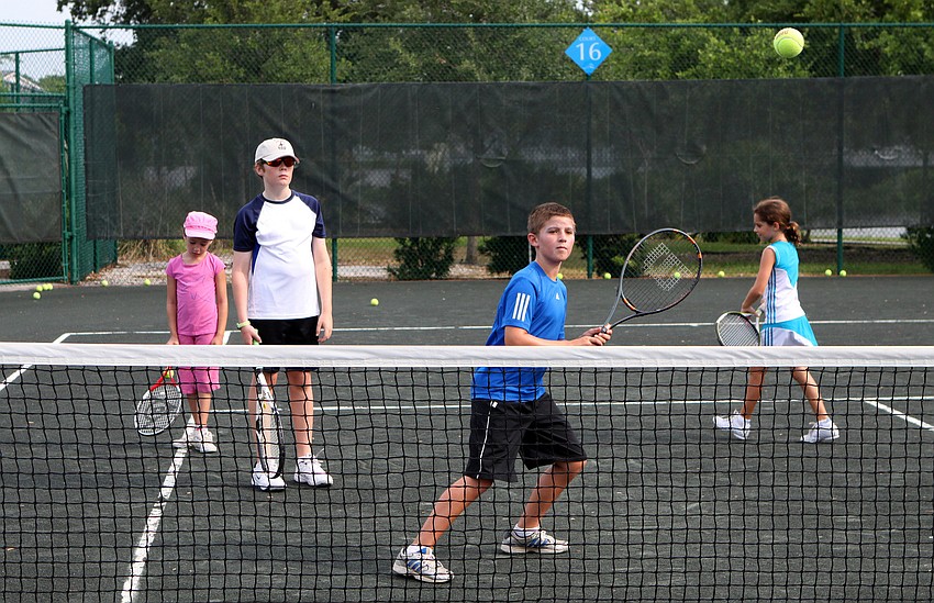 Carter Dunham, 10, gets ready to hit the ball during a volley drill at Longboat Key Club's Sports Camp Monday, June 6 at Longboat Key Club's Tennis Gardens.
