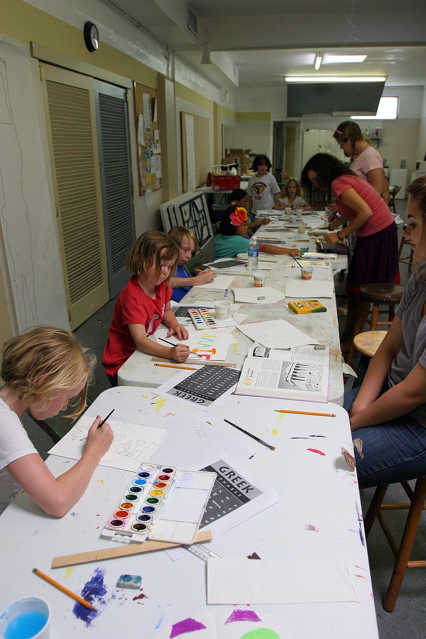 Kids works on writing and painting their names in Greek letters Tuesday, June 14 during the It's All Greek To Me! summer art class at Art Center Sarasota.
