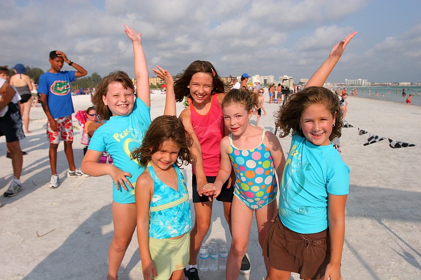 Chloe Johnson, 5, Emily Freed, 8, Emma Johnson, 9, Erika Smith, 7 and Grace Johnson, 7, pose after doing a cheer before the 1-mile fun run Tuesday, June 14 on Siesta Key Beach.